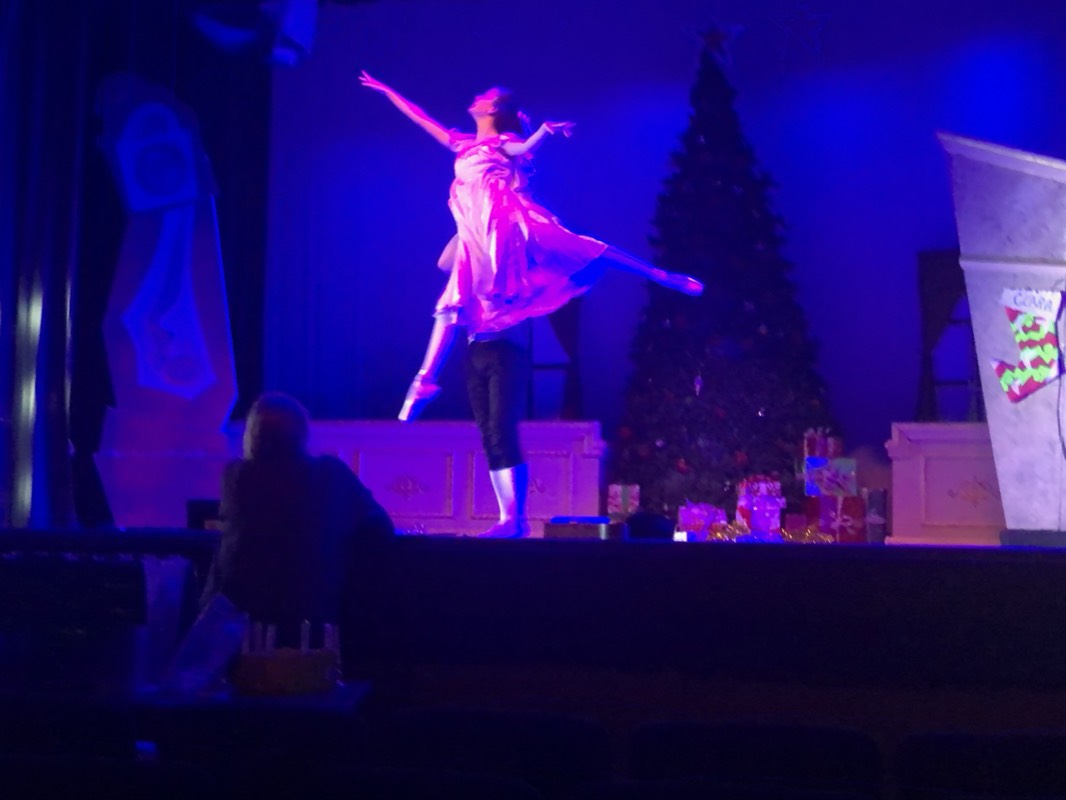 Mid-leap on stage during a Nutcracker performance